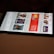 A smartphone displaying a streaming app interface, showing various movie and TV show thumbnails. The screen includes categories like 'For you' and 'New release hit films', with images from popular films. The background is a dimly lit setting with a fabric surface.